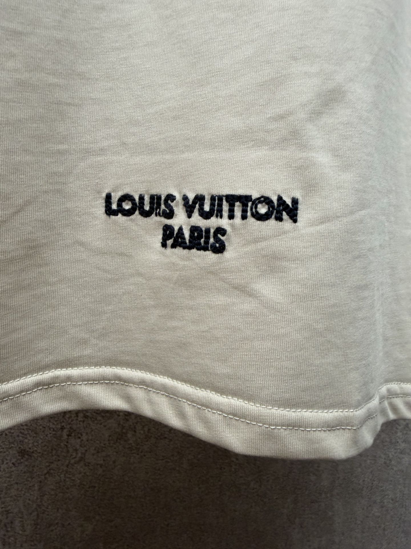 Louis Vuitton T-shirt with 'LOUIS VUITTON PARIS' print near the hem.
