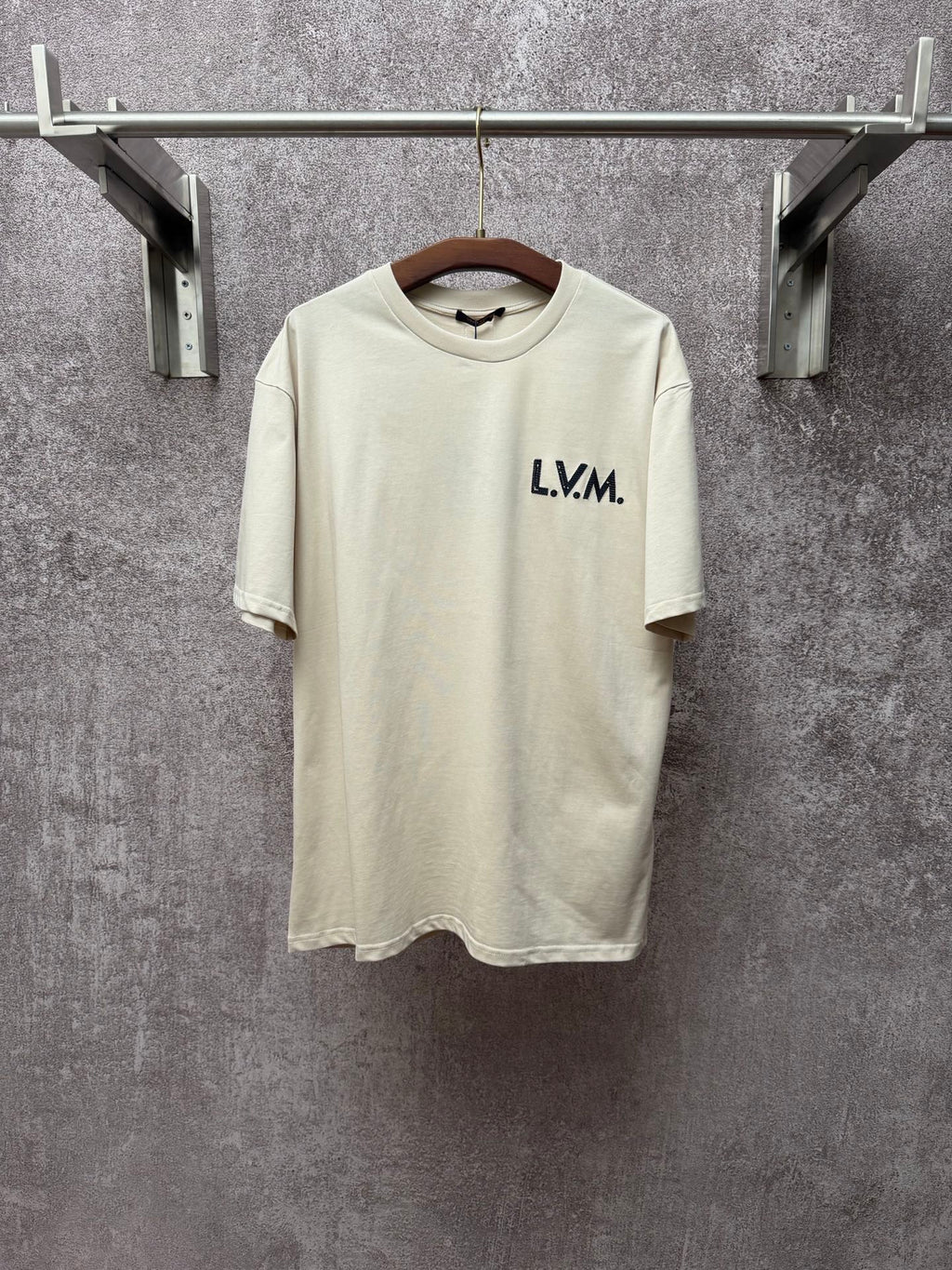 Louis Vuitton T-shirt in light cream with L.V.M. logo on the front chest.