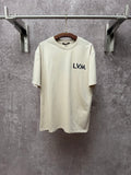 Louis Vuitton T-shirt in light cream with L.V.M. logo on the front chest.