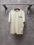Louis Vuitton T-shirt in light cream with L.V.M. logo on the front chest.