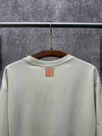 Louis Vuitton T-shirt in light cream back view with small leather brand patch.