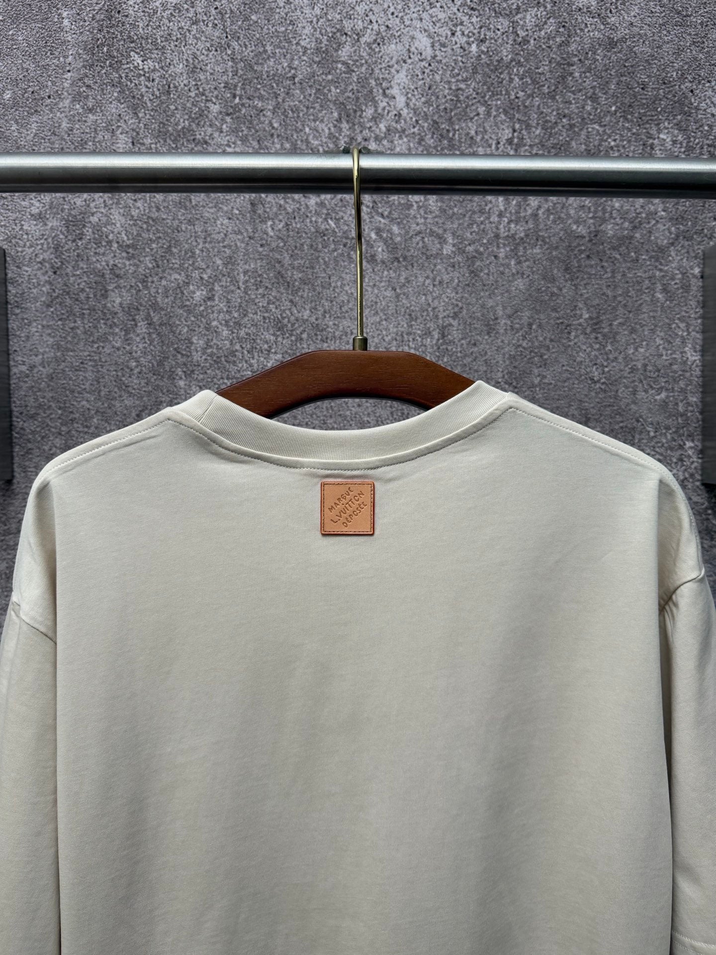 Louis Vuitton T-shirt in light cream back view with small leather brand patch.