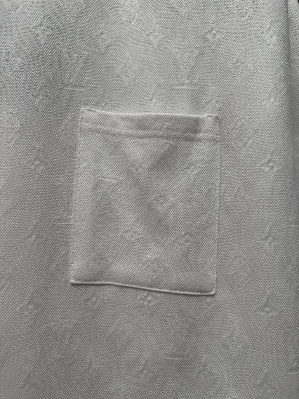 White T-shirt chest pocket detail with embossed textured fabric