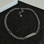 Silver-tone chain necklace with engraved bar and two heart-shaped charms