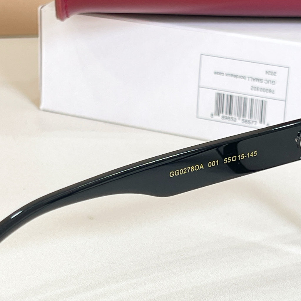 Black glasses temple close-up showing model numbers and fit code text.