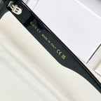 Black glasses side view with gold lettering and text on the temple, made in Italy.