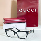 Black rectangular glasses with red and green striped temple details, with case and box.