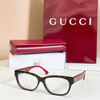Tortoiseshell glasses with red and green striped temple details, with case and box.