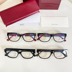 Two pairs of multicolor glasses with red and green stripe temples, shown with boxes.