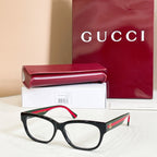 Black rectangular glasses with red and green striped temple details, with case and box.