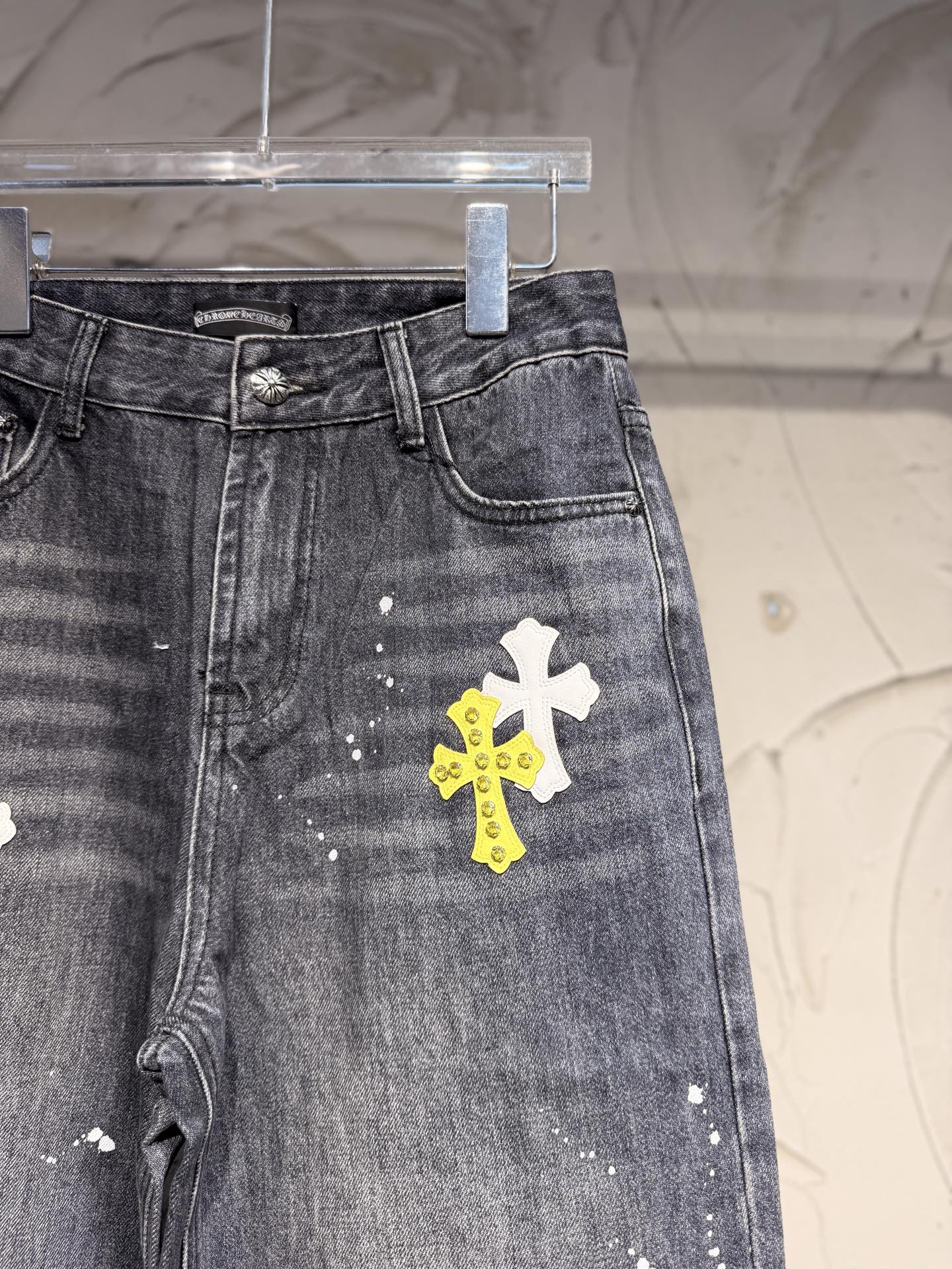 Dark gray denim pants with side view and large white cross graphic