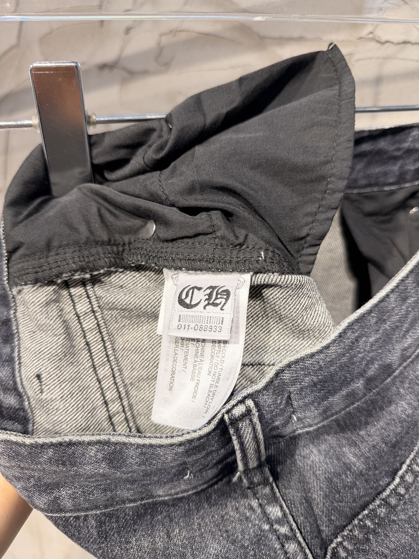 Dark gray denim pants waistband with inner brand label