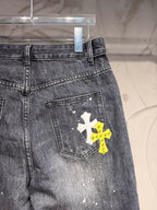 Dark gray denim pants with back pocket and yellow plus white cross graphic