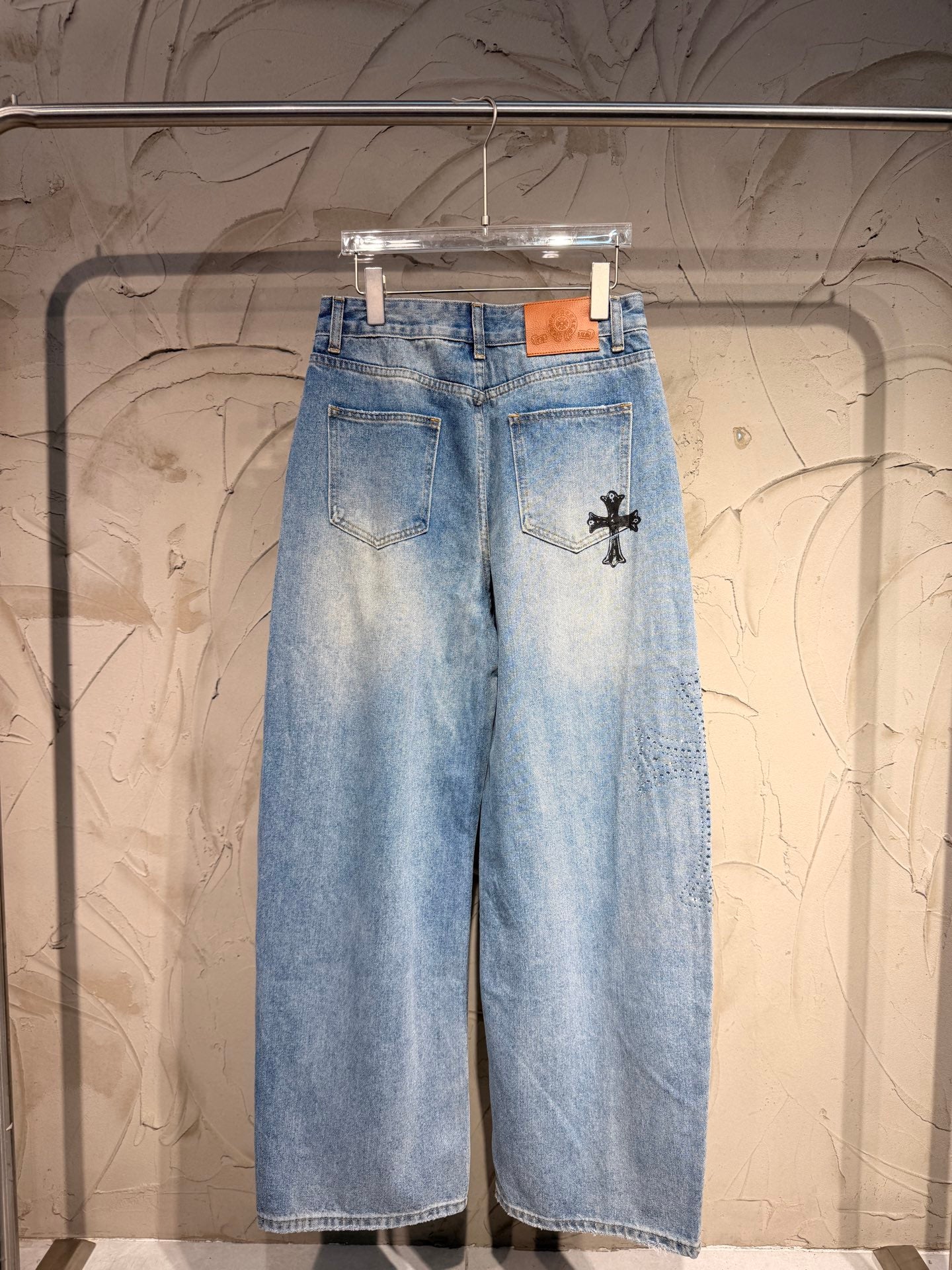 Light blue denim wide-leg pants with front cross patch