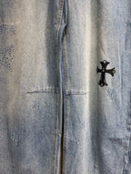 Light blue denim pants with black cross graphic on the side seam