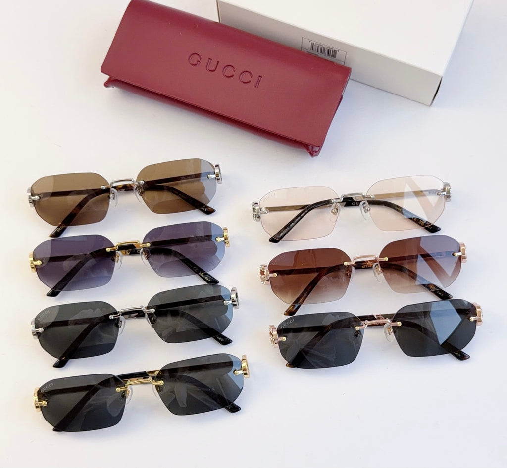 Set of Gucci sunglasses with dark lenses, gold frames, and tortoise temple accents