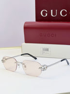 Gucci sunglasses with light lenses, clear frame, gold-toned bridge with round stud
