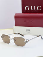 Gucci sunglasses with taupe lenses, gold frame, tortoise temples, round logo stud