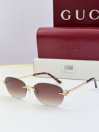 Gucci round sunglasses with gold-tone metal frame, tortoise temples, and dark lenses