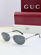 Gucci round sunglasses with gold-tone metal frame, black temples, and dark lenses