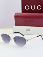 Gucci round sunglasses with gold-tone metal frame, black temples, and dark lenses
