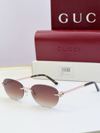 Gucci round sunglasses with gold-tone metal frame, tortoise temples, and dark lenses