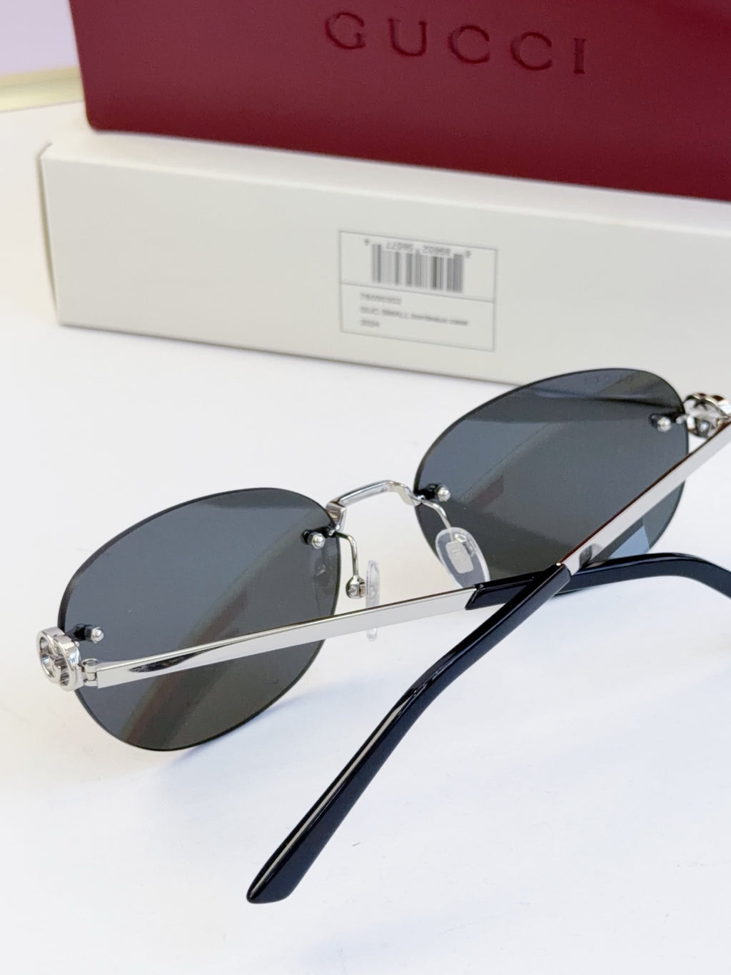 Gucci round sunglasses with gold-tone frame, black temples, and dark blue lenses