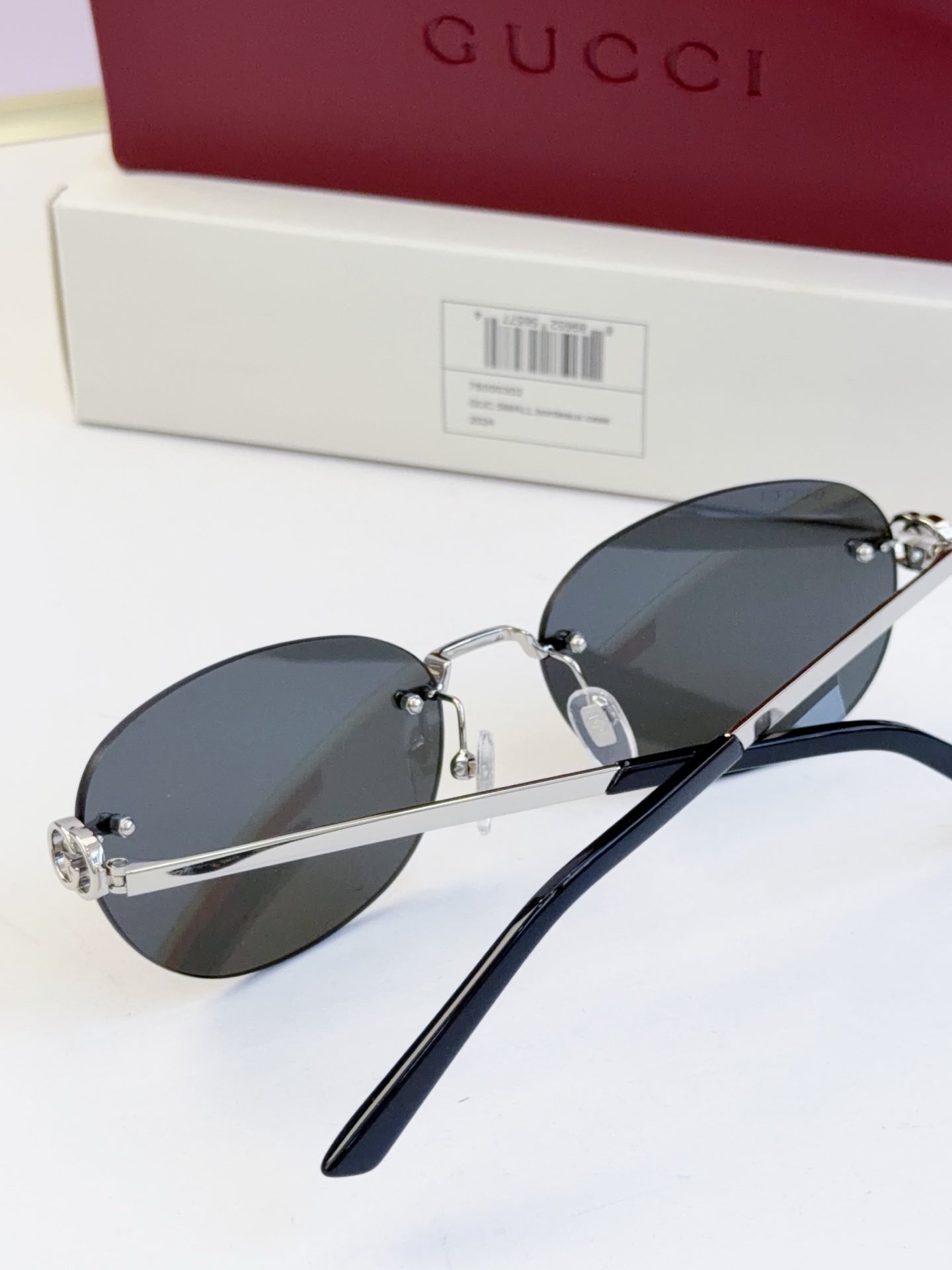 Gucci round sunglasses with gold-tone frame, black temples, and dark blue lenses