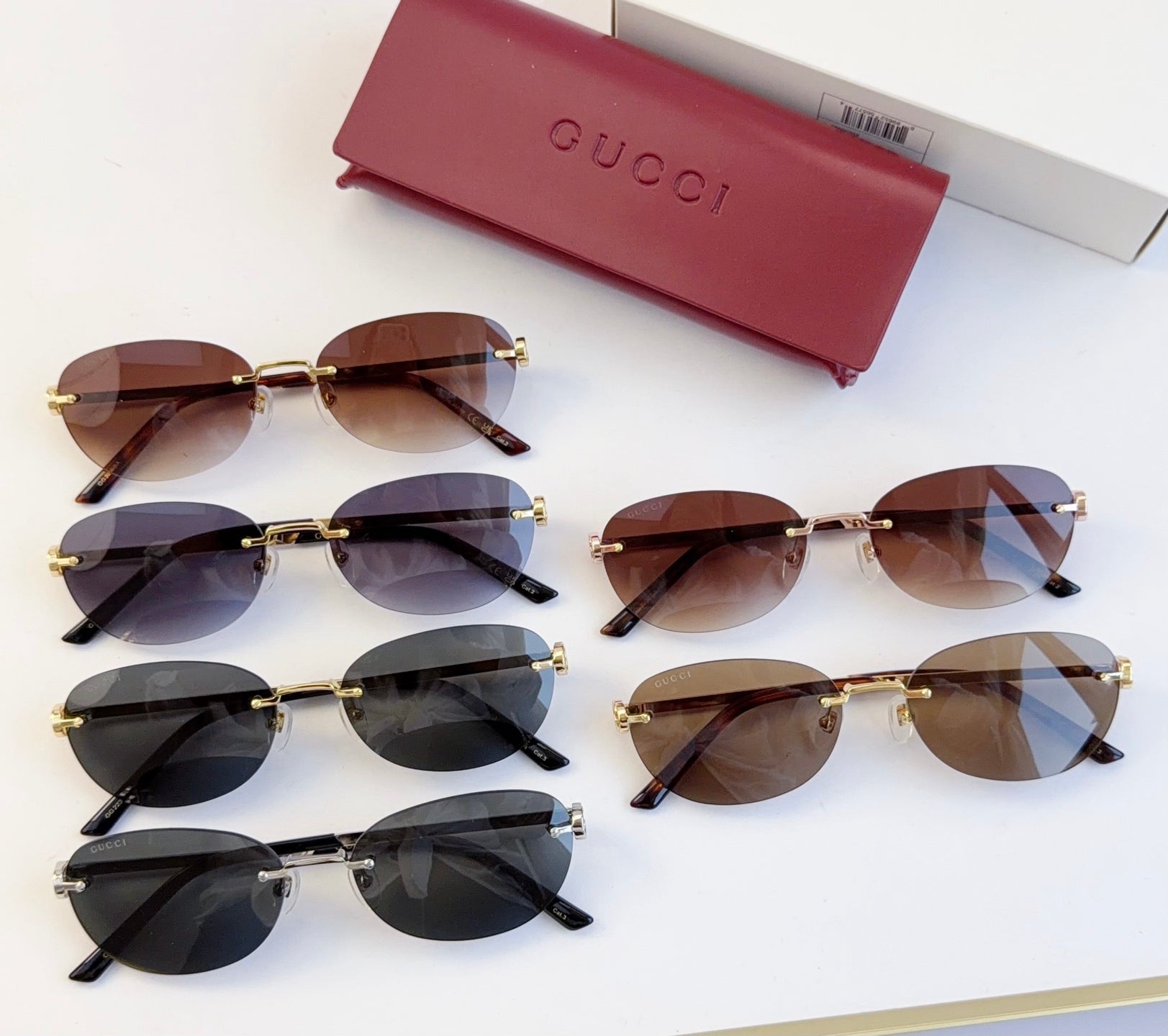Gucci round sunglasses assortment with gold-tone frames and dark lenses in multiple colors