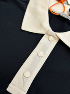 Moncler polo shirt placket detail with cream buttons on dark navy fabric
