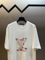 White crewneck T-shirt with multicolor floral appliqué on the chest