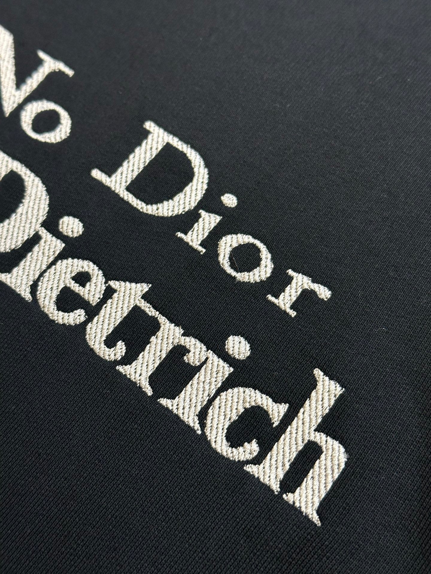 'No Dior No Dietrich' text print on black sweatshirt fabric