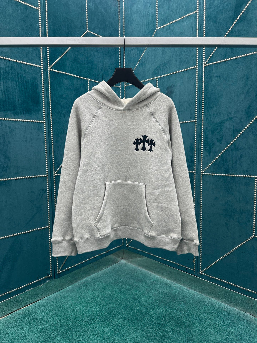 Light gray pullover hoodie with chest logo and front kangaroo pocket