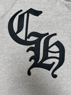 Light gray hoodie with black decorative monogram logo on chest