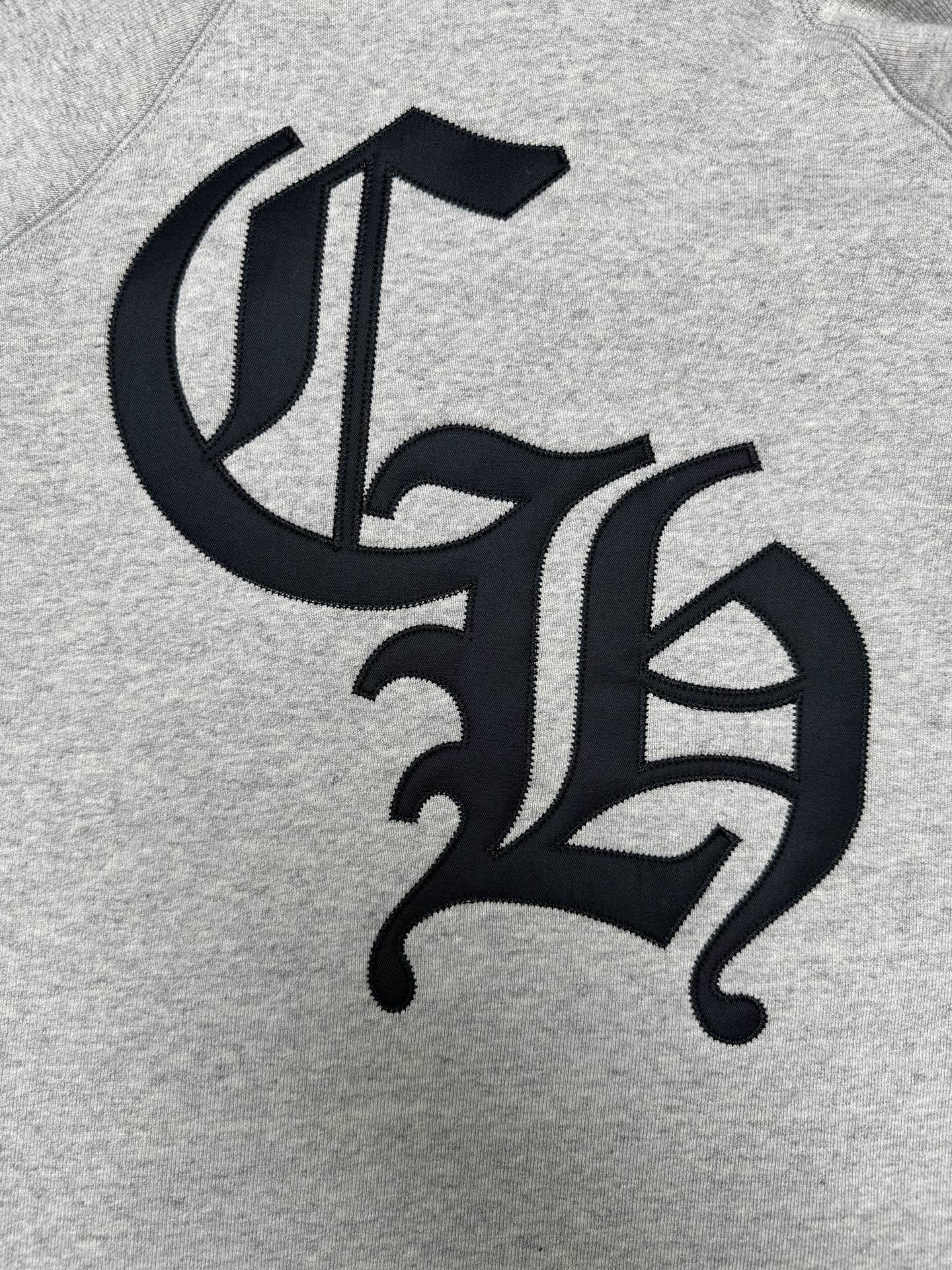 Light gray hoodie with black decorative monogram logo on chest