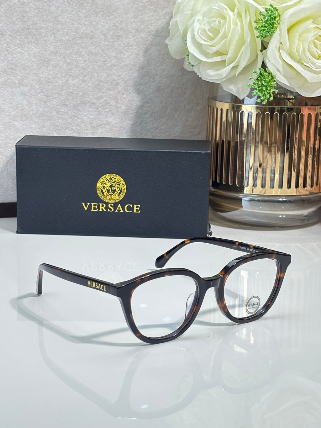 Eyeglasses with dark round frames and tortoiseshell-patterned temples