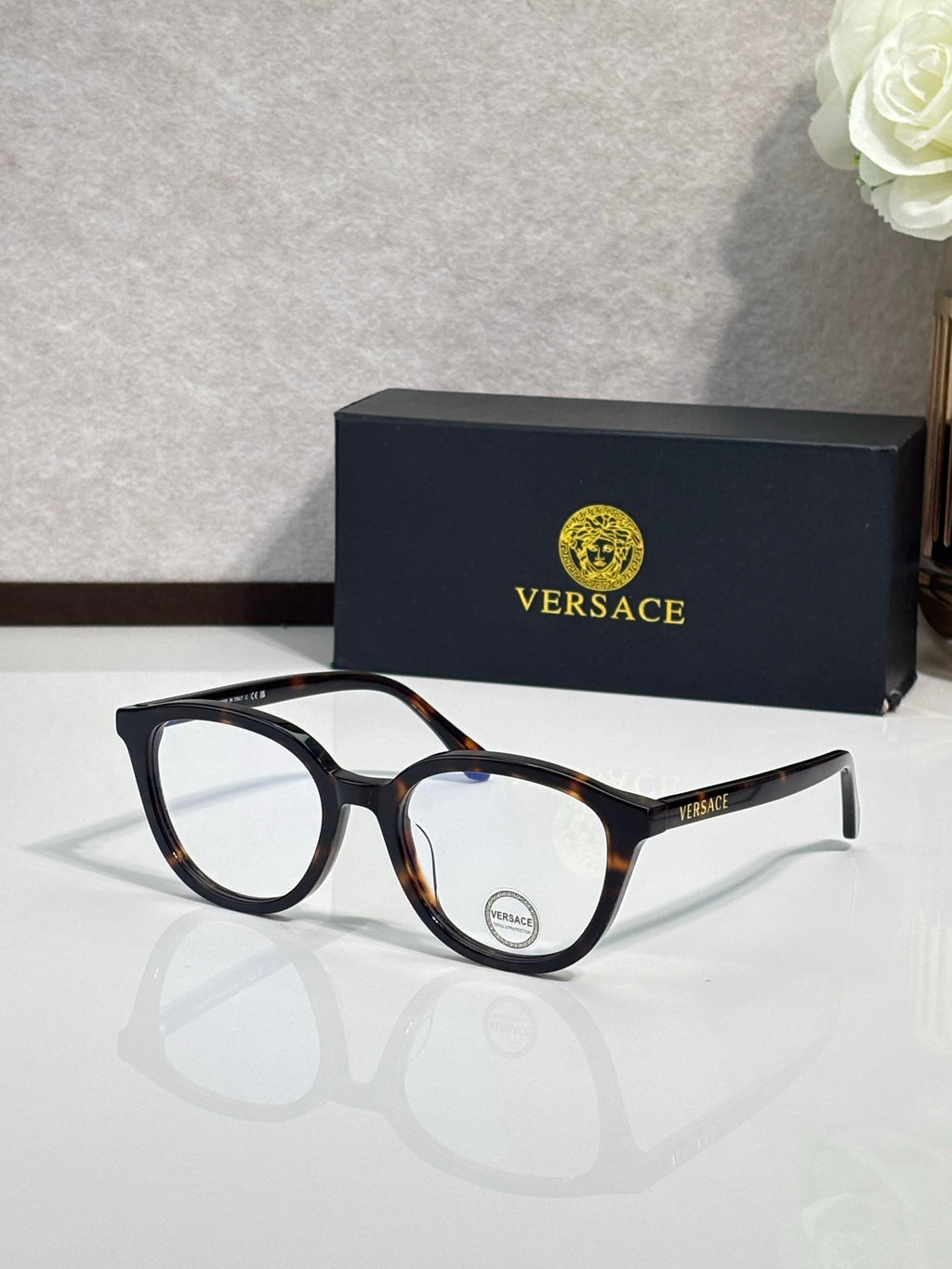 Eyeglasses with dark tortoiseshell round frames and clear temple details