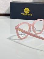 Eyeglasses with blush pink round frames and gold-tone logo badge