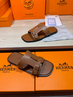 Hermes brown leather sandals with double straps and metal buckle, front close-up