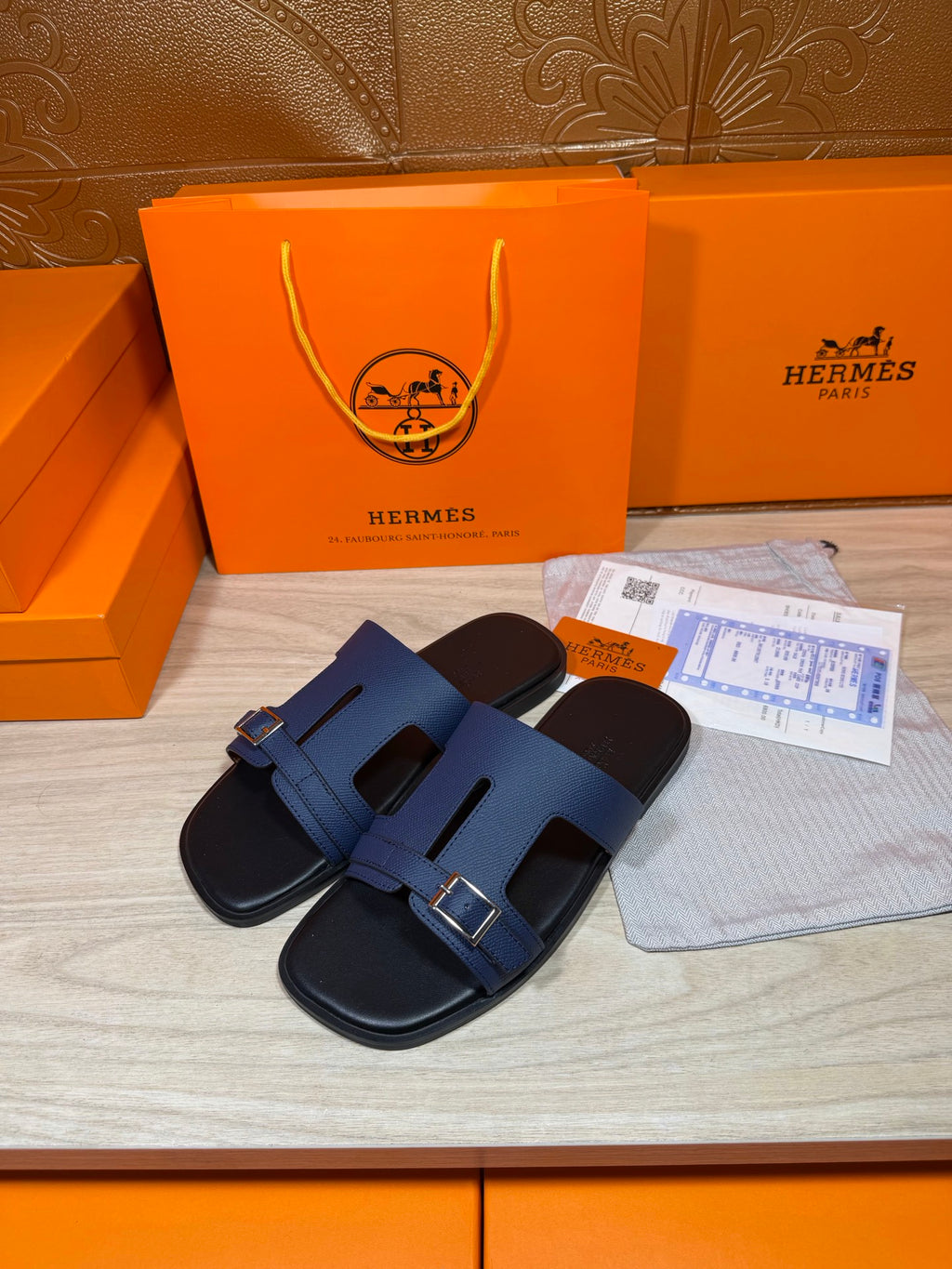 Navy slip-on sandals with double straps and silver-tone buckle detail on footbed