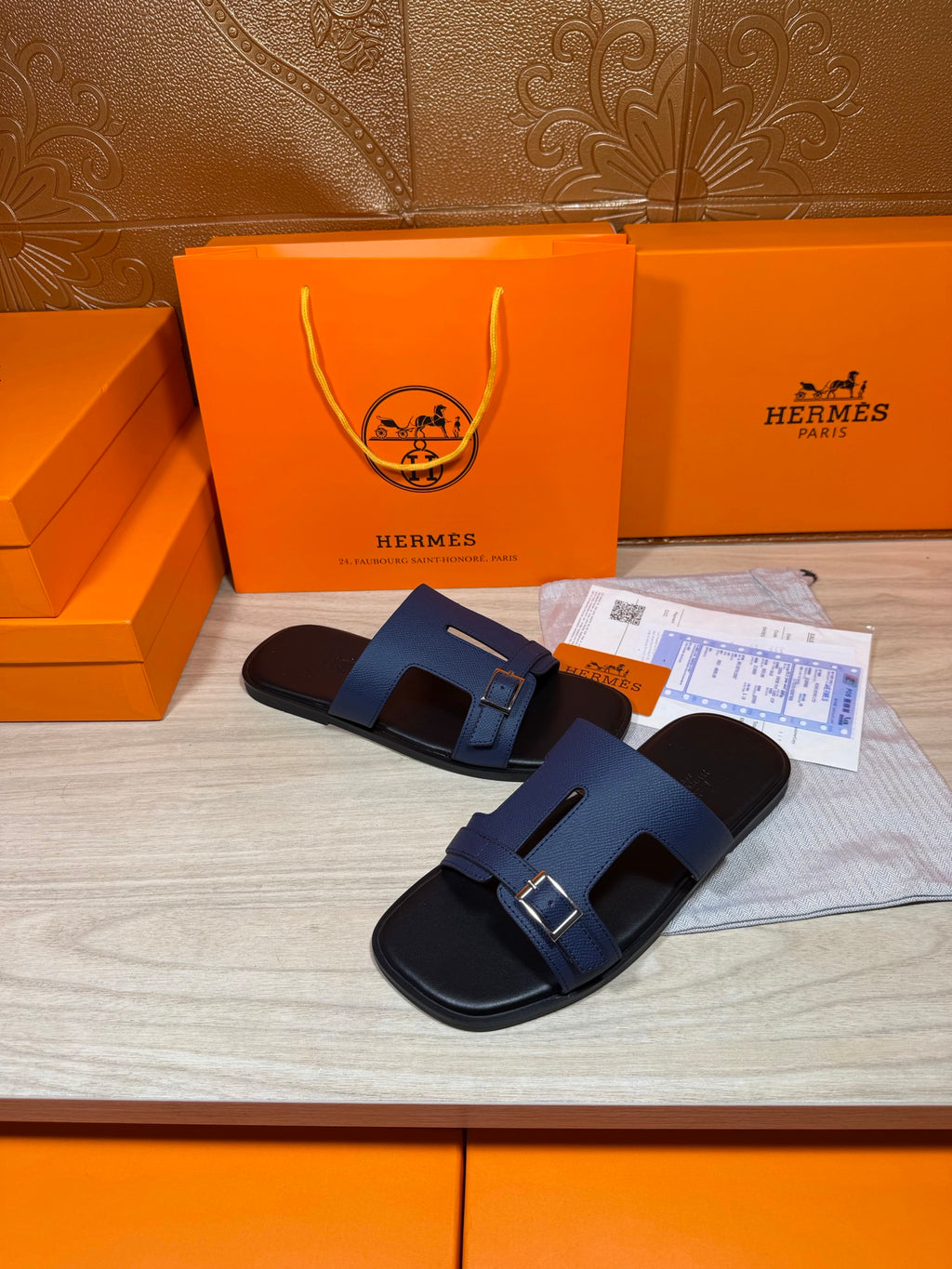 Navy two-strap slide sandals with silver buckle closures, front angled view