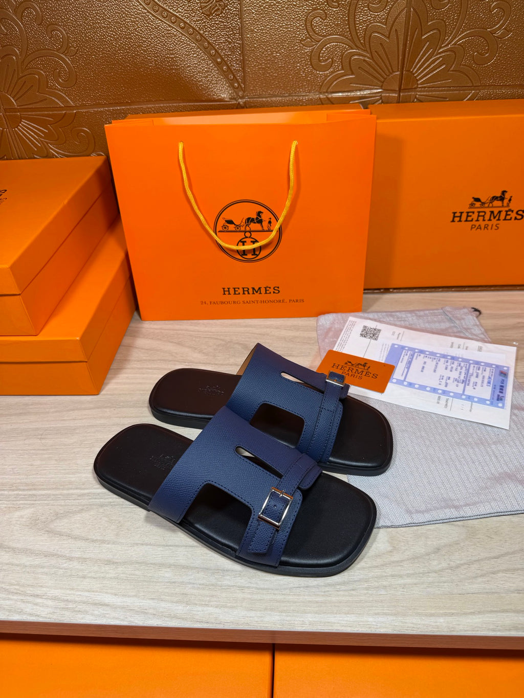 Navy sandal slides with two adjustable straps and silver buckle accents, side view