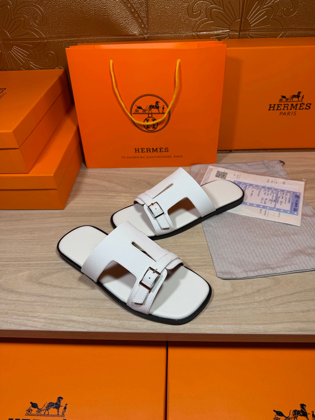 White leather slide sandals with square buckle hardware on two straps