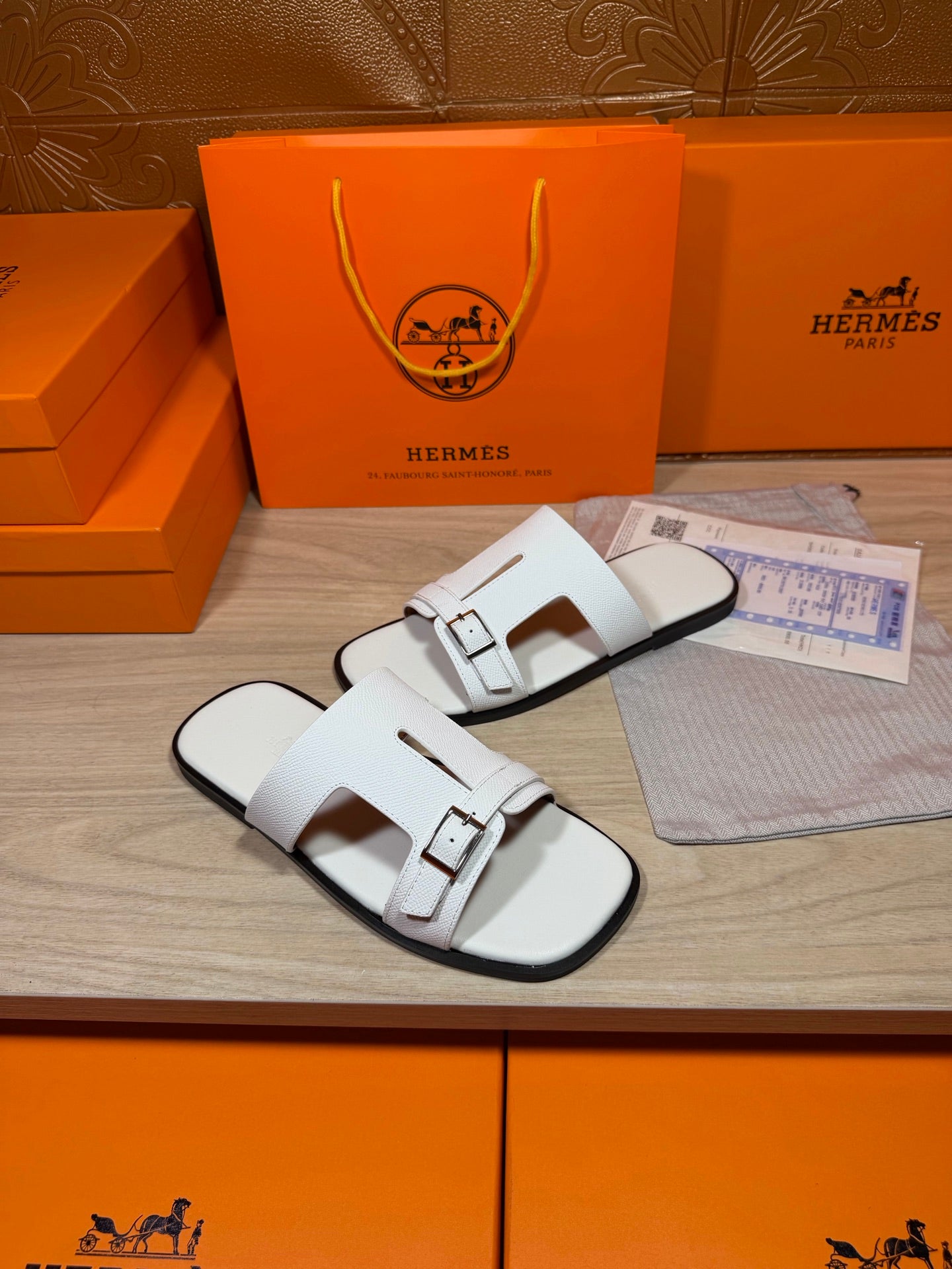 White leather slide sandals with square buckle hardware on two straps