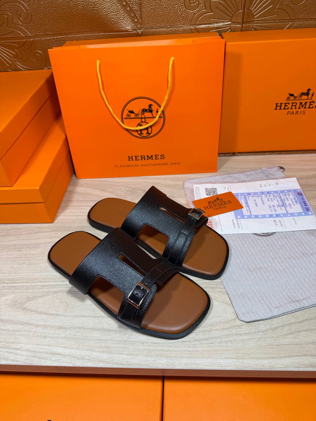 Hermes dark blue slide sandals with wide cross straps and rectangular buckle accents