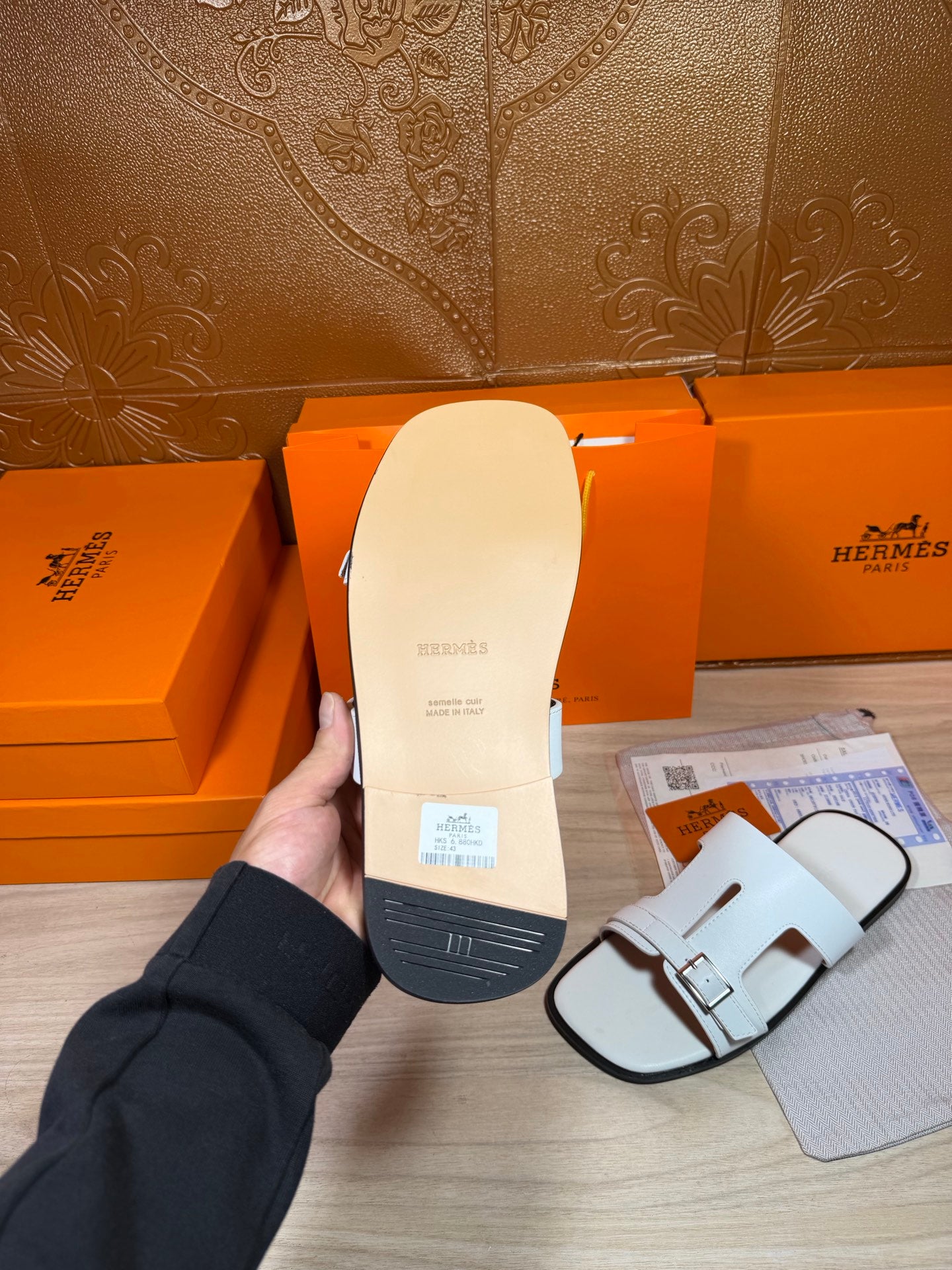 Sandal sole view in white, with side buckle strap detail