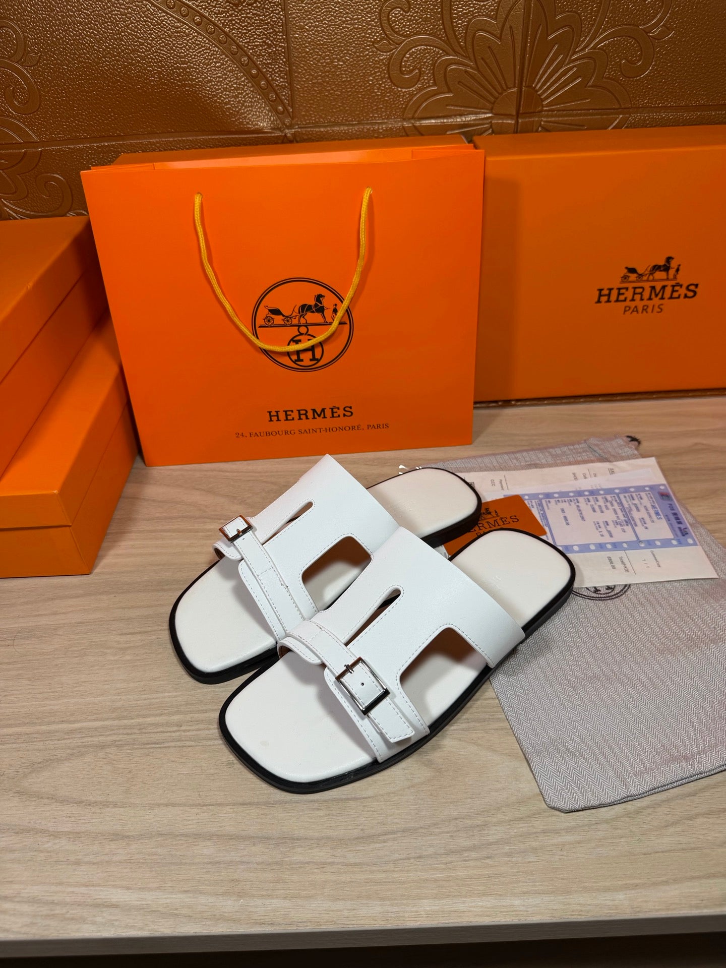 White slide sandals with front cutout straps and adjustable buckle closures