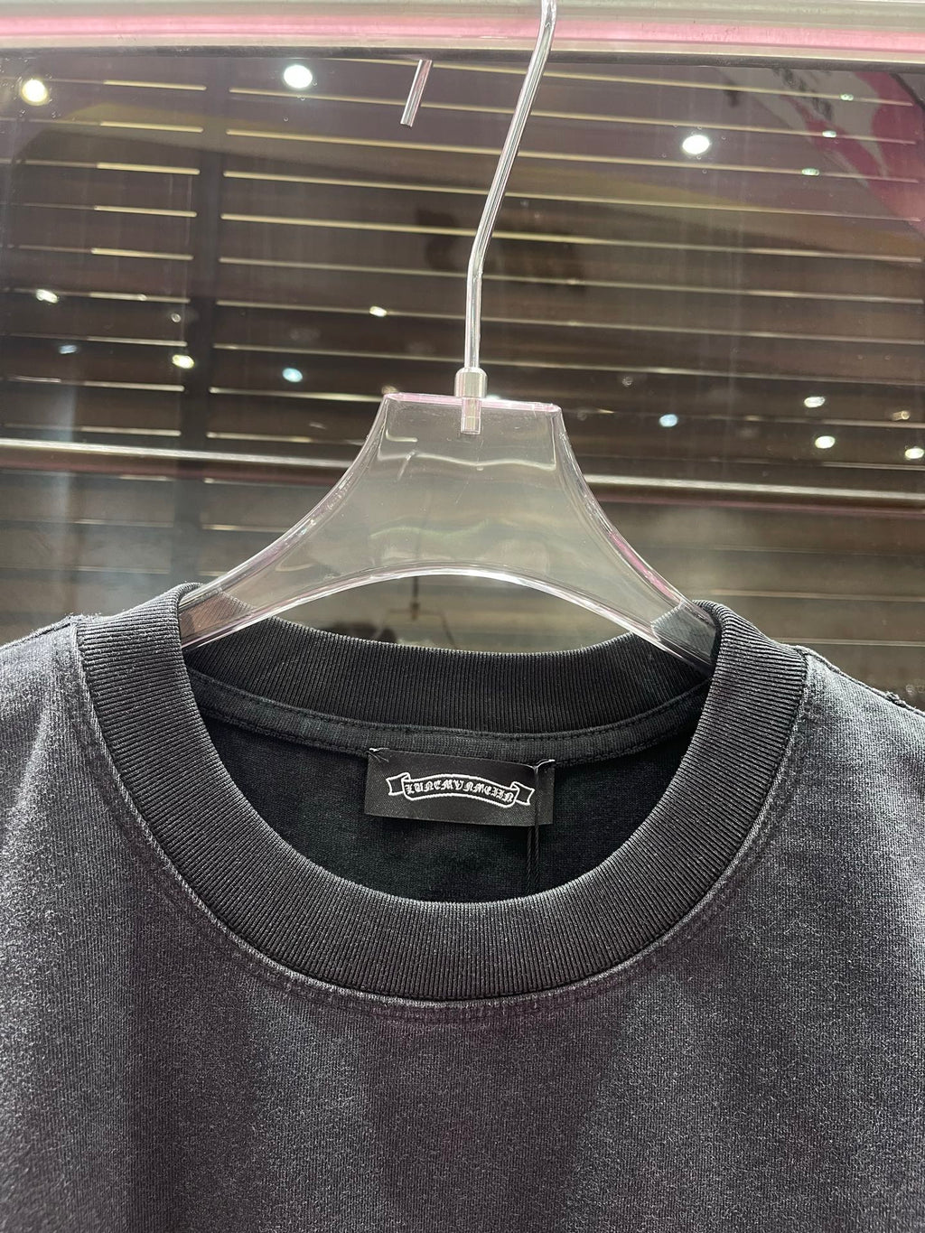 Crewneck graphic T-shirt neckline and collar detail in dark charcoal