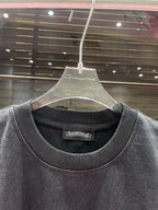 Crewneck graphic T-shirt neckline and collar detail in dark charcoal