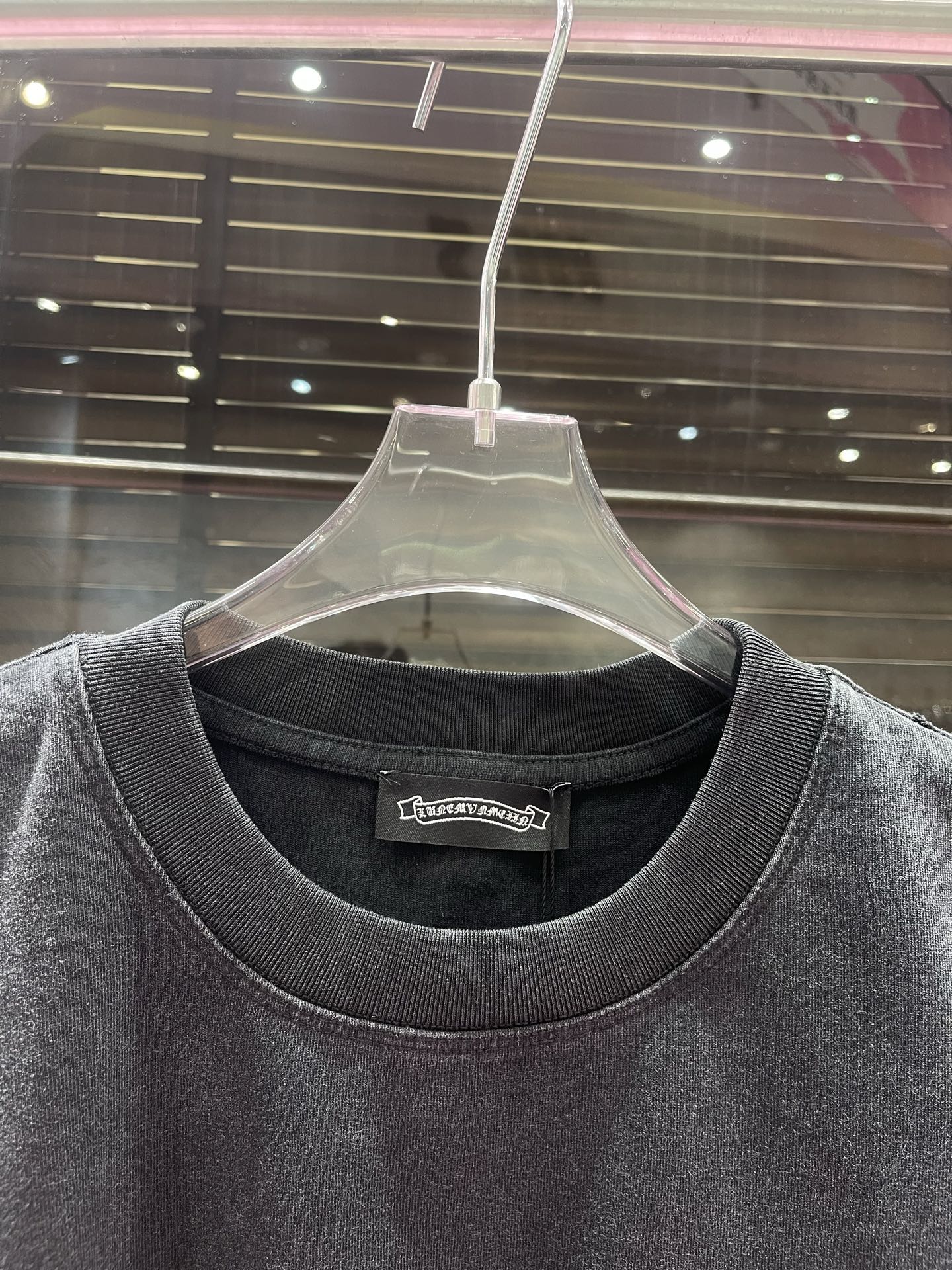 Crewneck graphic T-shirt neckline and collar detail in dark charcoal